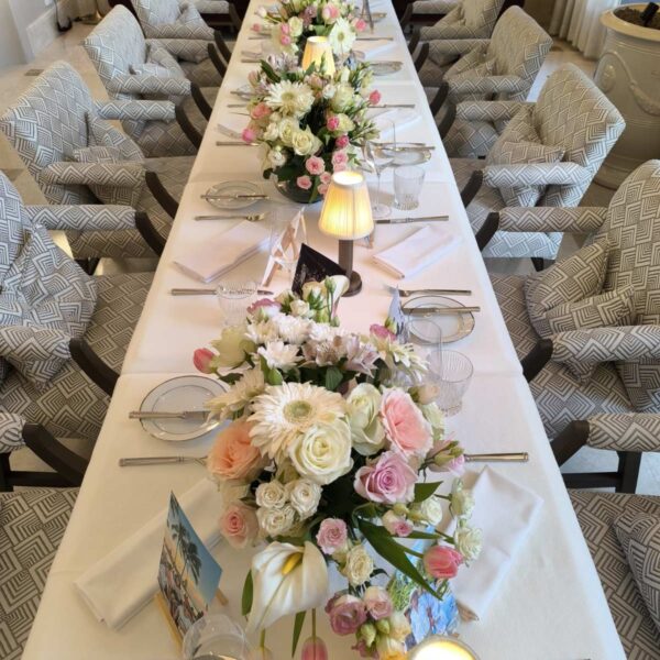 dekoracija stola za proslavu sa cvetnim aranžmanima i svećama